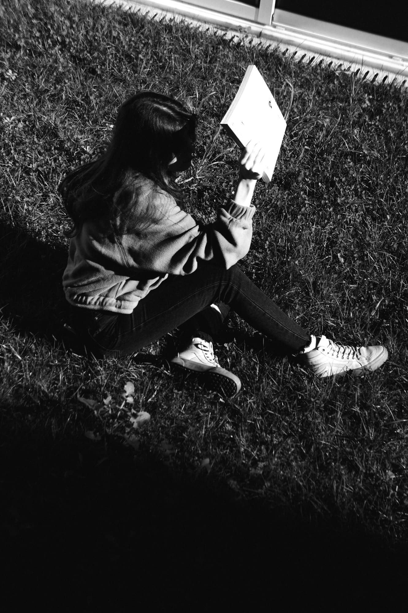 person blocking sun with magazine